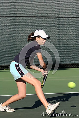 Young girl playing tennis