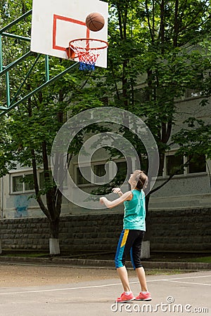 Young girl shooting a goal in basketball