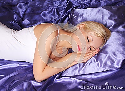 Young girl sleeping on silk bed