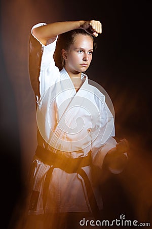 Young girl in a sports kimono in the image of judo.