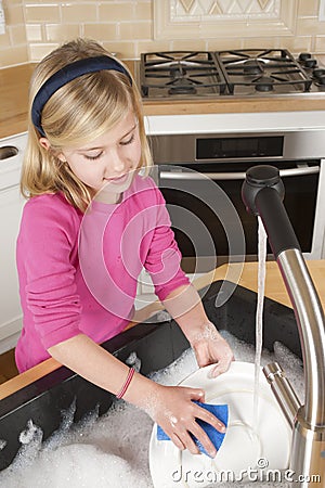 Young girl washing dishes
