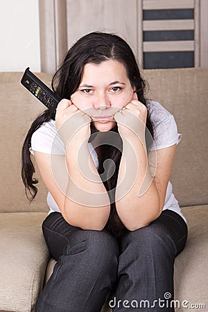 Young girl watching TV at home