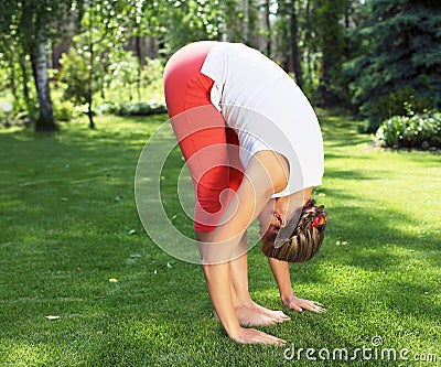 Young girl in a white shirt and red pants