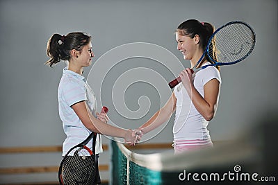 Young girls playing tennis game indoor