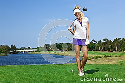 Young golfer girl on golf course