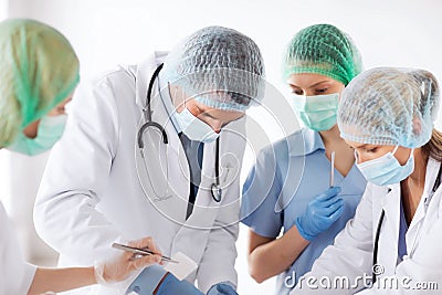 Young group of doctors doing operation