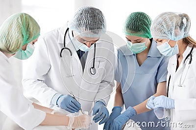 Young group of doctors doing operation