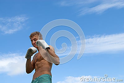 Young guy in boxing gloves