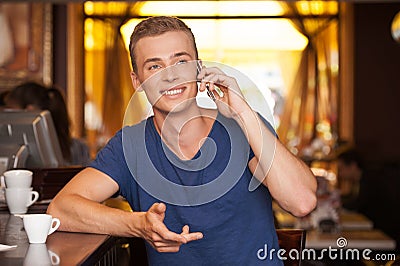 Young handsome man talking on phone.
