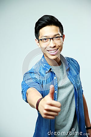 Young happy asian man showing thumbs up