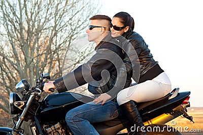 Young happy couple riding a motorcycle