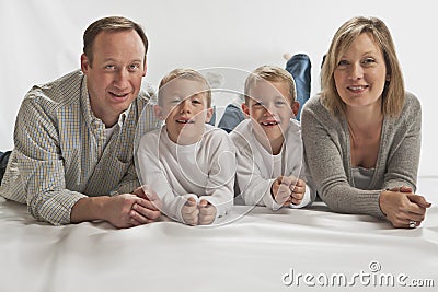 Young happy family with two identical twins