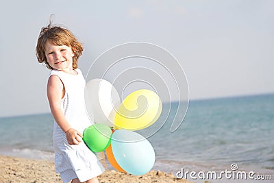 Young happy girl with balloons on sea background