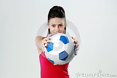 Young happy sport woman giving you a soccer ball