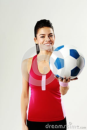 Young happy sport woman holding a soccer ball