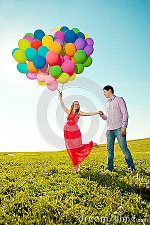 Young healthy beauty pregnant woman with her husband and balloon