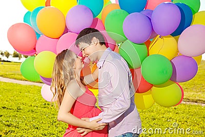 Young healthy beauty pregnant woman with her husband and balloon