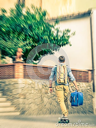 Young hipster man moving with his longboard and luggage