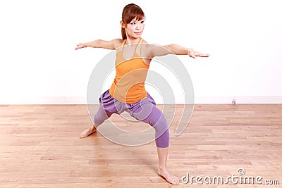 Young Japanese Woman Doing YOGA warrior 2 pose