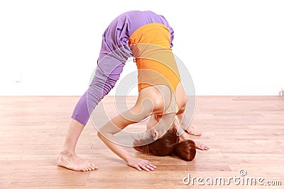 Young Japanese Woman Doing YOGA wide legged forward bend pose