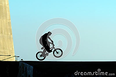 Young jumping with bicycle