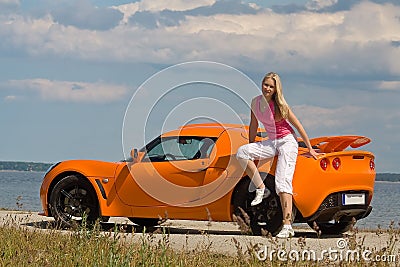 Young lady posing near a car