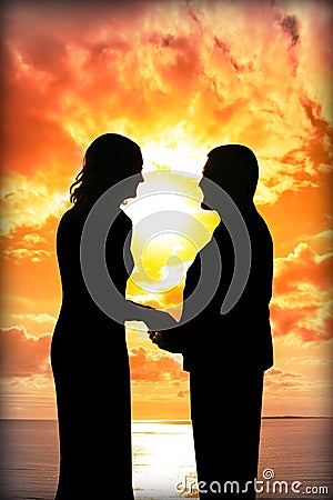 Young loving couple holding hands in silhouette