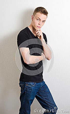 Young male leaning on wall portrait