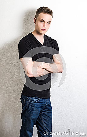 Young male leaning on wall portrait