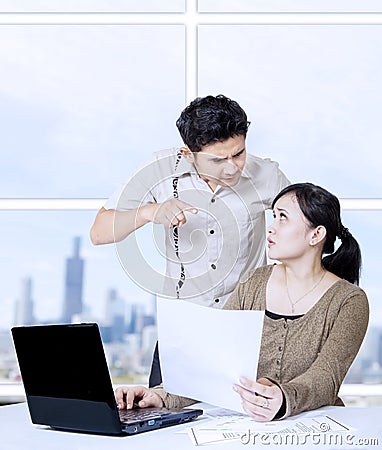 Young man angry at secretary in office