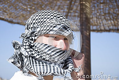 Young man with arab scarf in face