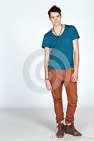 Young man in blue tanktop and scarf pose isolated