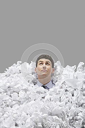 Young Man Covered In Crumpled Papers