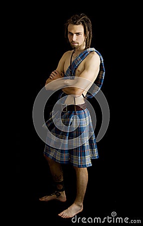 Young man dressed in a scottish kilt