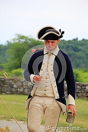 Young man dressed in soldier s uniform enjoying his pipe and cup of coffee,Fort Ticonderoga,New York, 2014