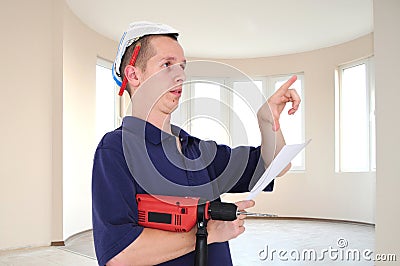 Young man with drill and paper hat