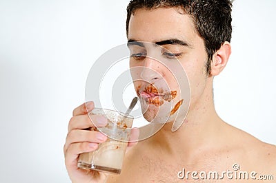 Young man drinking chocolate milkshake
