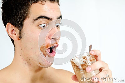 Young man drinking chocolate milkshake