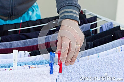 Young man drying clothes after laundry