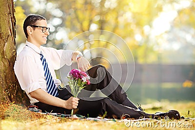 Young man with flowers - expecting someone