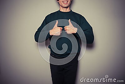 Young man giving thumbs up