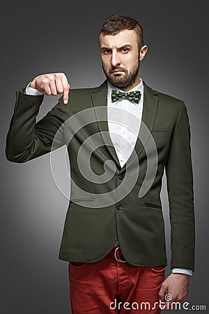 Young man in a green suit, pointing down