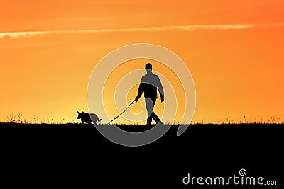 Young man with his dog - back lit