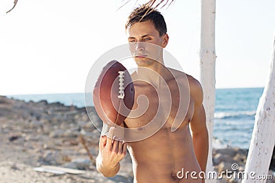 Young man holding a rugby ball
