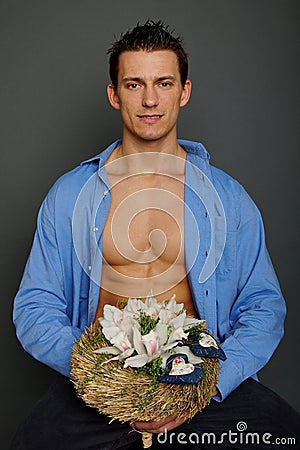 Young man holds a bouquet of Orchids