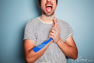 Young man with kinesio tape on his arm