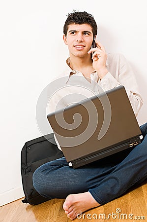 Young man on laptop and mobile