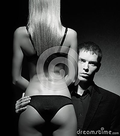 A young man looking from the back of a sexy woman