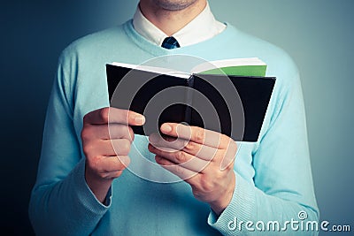 Young man with open notebook