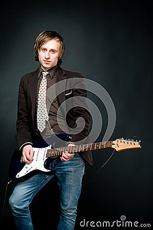 Young man playing electro guitar